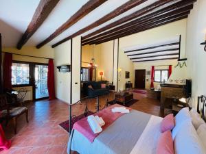 a bedroom with a large bed and a living room at Villa Inserra Deluxe in Palermo