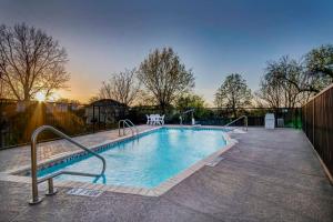 a swimming pool with metal rails around it at Motel 6-San Antonio, TX - Sea World North in San Antonio