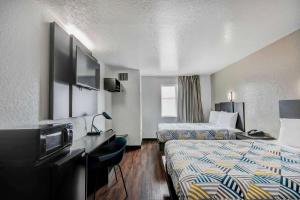 a hotel room with two beds and a television at Motel 6-San Antonio, TX - Sea World North in San Antonio +20 photos