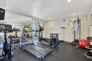 a gym with several exercise bikes and a mirror at Best Western Plus Marina Shores Hotel in Dana Point