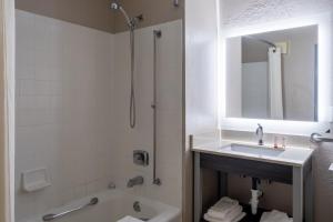 a bathroom with a sink and a shower and a tub at Super 8 by Wyndham Merrillville in Merrillville +26 photos