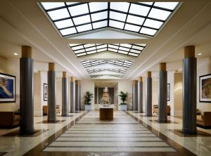 a large lobby with columns and a skylight at Sonesta Redondo Beach and Marina in Redondo Beach