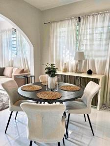 a dining table and chairs in a living room at Breathtaking 2-Bedroom Beachside Apartment in San Juan