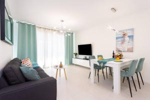 a living room with a couch and a table with chairs at Amazing Brand New Apartment in Santa Cruz in Santa Cruz de Tenerife