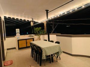 a dining room with a table and chairs and lights at Capaclan Centro Private Room in Romblon