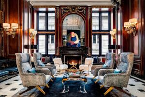 a living room with chairs and a fireplace at The Blackstone, Autograph Collection in Chicago