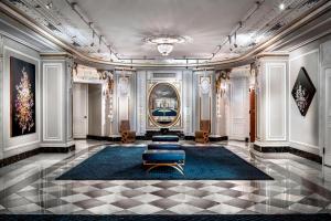 a room with a lobby with a couch and a rug at The Blackstone, Autograph Collection in Chicago