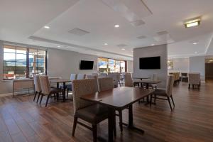 a dining room with tables and chairs and televisions at TownePlace Suites by Marriott San Luis Obispo in San Luis Obispo