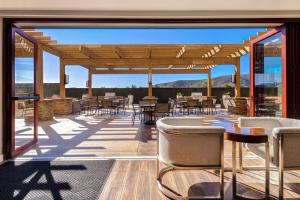a patio with tables and chairs on a deck at TownePlace Suites by Marriott San Luis Obispo in San Luis Obispo