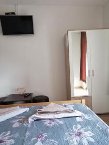 1 dormitorio con 1 cama con tocador y espejo en Guest House Končar, en Lagos de Plitvice