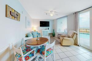 a living room with a table and chairs at Perdido Skye G3 in Perdido Key