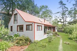 a small white house with a red roof at Arcadia in Wentworth Falls