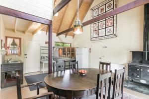 a kitchen and dining room with a wooden table and chairs at Arcadia in Wentworth Falls