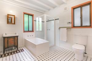 a bathroom with a tub and a toilet and a sink at Arcadia in Wentworth Falls +12 photos