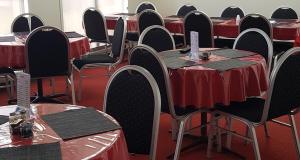 a row of tables with red table cloths at Three Moon Motel in Monto