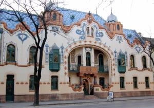 an ornate building with a blue roof at Vidak Apartman in Subotica