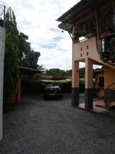 a car parked in the driveway of a house at Résidence Canopée in Libreville