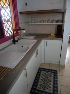 a kitchen counter with a sink and a window at Résidence Canopée in Libreville