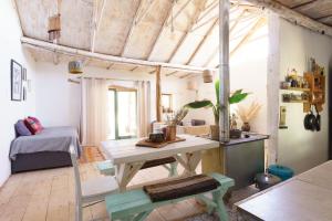 a room with a table and a bed in it at EcoCasa Sutar in San Pedro de Atacama