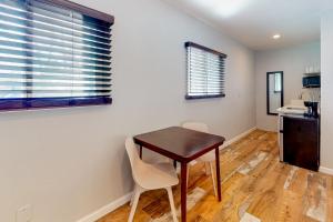 a small table and chairs in a room with a kitchen at Humphreys - Studio in Flagstaff