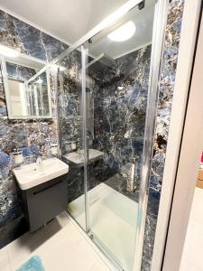 a bathroom with a shower and a sink at Garden View in Northfleet