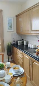 a kitchen with a table with bowls of food on it at Havana Holiday Cottage Inishowen 