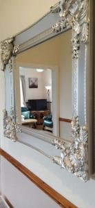 a mirror hanging on a wall in a living room at Havana Holiday Cottage Inishowen 