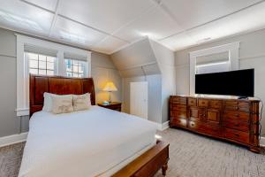 a bedroom with a bed and a flat screen tv at Town of Rehoboth Beach 4 Maryland Ave in Rehoboth Beach +41 photos