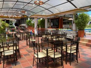 a patio with tables and chairs in a restaurant at Hosteria Casa Silva in Checa