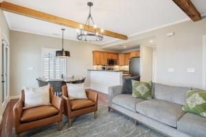 a living room with a couch and chairs and a kitchen at Emerald Bay Unit 1B in Lake Ozark