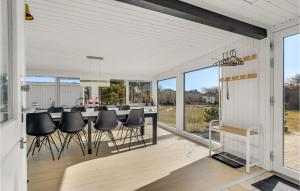 a kitchen and dining room with a table and chairs at 4 Bedroom Beautiful Home In Hvide Sande in Nørre Lyngvig