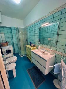 a bathroom with a sink and a toilet at Baia camerini in Villanova di Ostuni