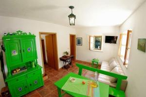 a living room with a green cabinet and a table at Secluded fisherman's cottage Cove Vela Studena, Brac - 20904 in Selca