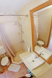 a bathroom with a shower and a sink and a mirror at Secluded fisherman's cottage Cove Vela Studena, Brac - 20904 in Selca