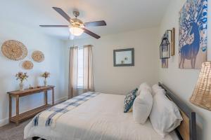 a bedroom with a bed with a ceiling fan at Secret Garden in San Antonio