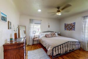 a bedroom with a bed and a dresser and a window at Charming! King bed, W/D, A/C, Garage in Twin Falls