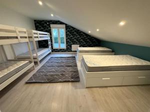 a bedroom with two bunk beds and a staircase at Gite 5 chambres, piscine intérieure, proche du Der 