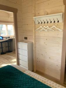 a bedroom with a bed and a wooden wall at Dolmen Lodge. in Donegal