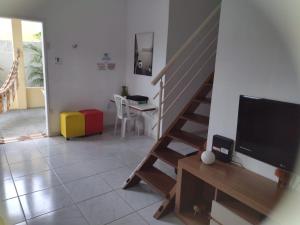 sala de estar con TV y escalera en CASA À 3 KM PRAIA TAMBAÚ, en João Pessoa