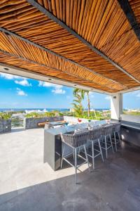 an outdoor patio with a table and chairs at Kippal - Modern Oasis - ApartHotel in Cozumel