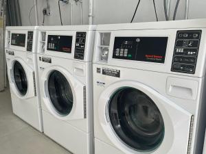 two white washing machines sitting next to each other at Stunning 3-Bedroom Beachside Apartment in San Juan