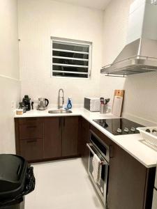a kitchen with a sink and a stove top oven at Stunning 2-Bedroom Apartment in San Juan