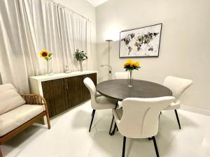 a dining room with a table and chairs and a couch at Stunning 2-Bedroom Apartment in San Juan