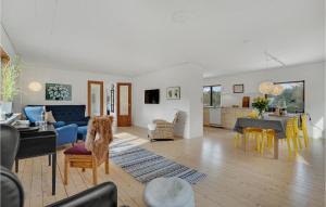 a living room with a couch and a table at Stunning Home In Randbl With Wifi And 3 Bedrooms in Randbøl