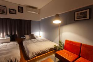 Postel nebo postele na pokoji v ubytování Code Rooms Imaizumi