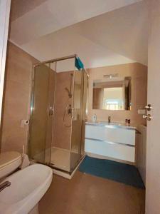 a bathroom with a shower and a toilet and a sink at Baia camerini in Villanova di Ostuni