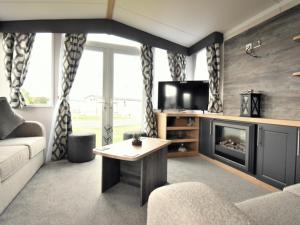 a living room with a couch and a fireplace at Whitstable retreat in Seasalter