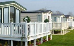 a row of houses with white railings and a porch at Whitstable retreat in Seasalter