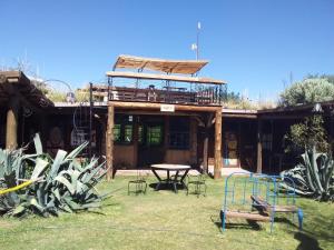 a building with a picnic table and a playground at Hostel Al Infinito in San Javier