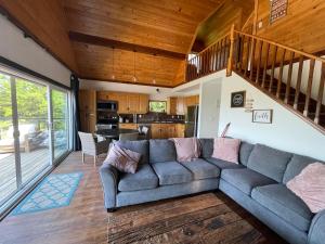 a living room with a couch and a kitchen at Home of the Living Sunset in Miller Lake